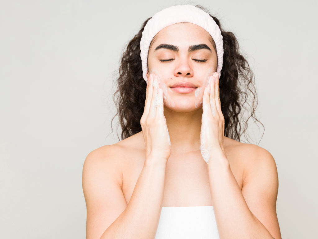 A picture of a woman using a gentle skin cleanser. 