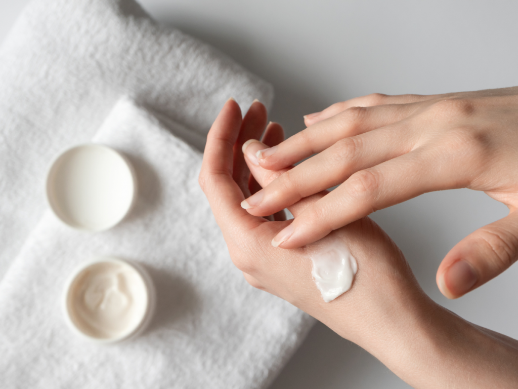 A picture of a woman rubbing in moisturizer into her skin. Skincare essentials: Moisturizer