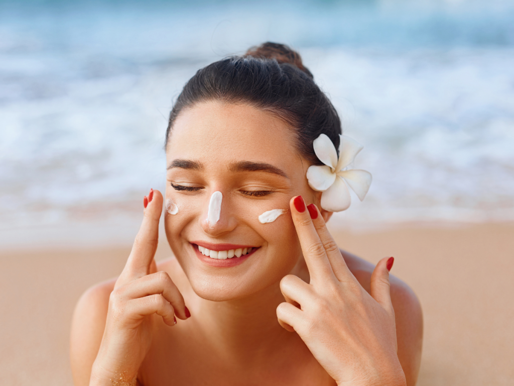 A picture of a woman applying sunscreen. - Skincare essentials: Daily Sunscreen