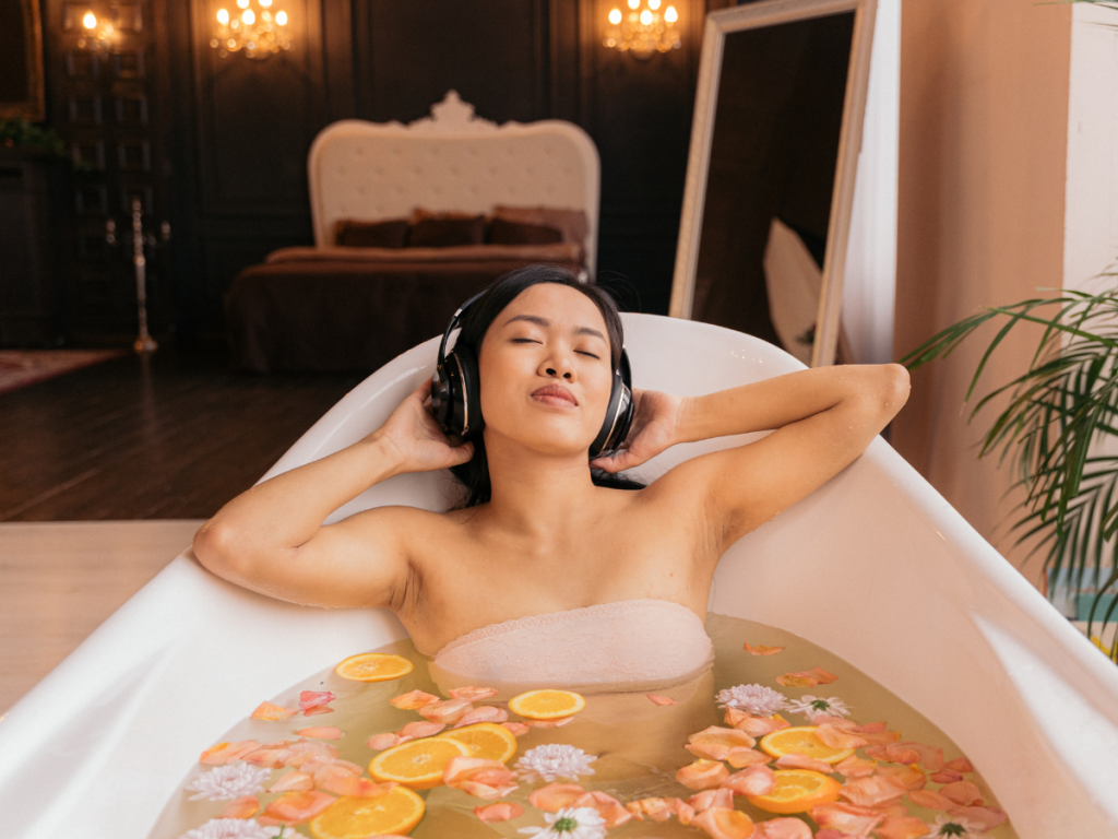 A woman relaxing in the tub listening to soothing sounds
