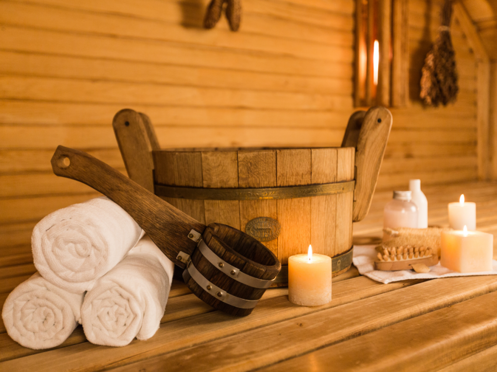 A picture of a sauna filled with candles, towels and other accessories