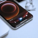 black smartphone on white table