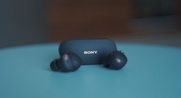 black sony headphones on blue table