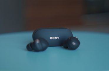 black sony headphones on blue table